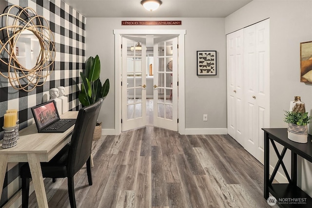 office space featuring baseboards, wood finished floors, and french doors