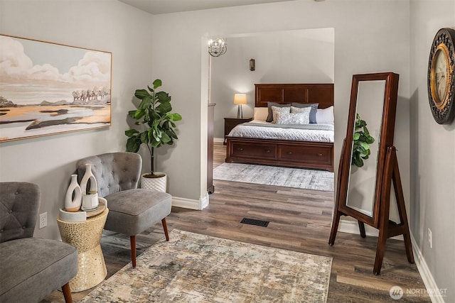 bedroom with baseboards, visible vents, and dark wood-style flooring