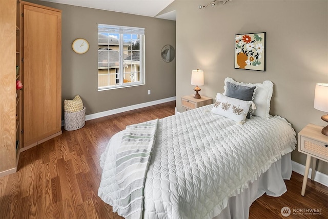 bedroom featuring baseboards and wood finished floors