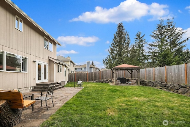 view of yard featuring french doors, a fenced backyard, a patio, and a gazebo