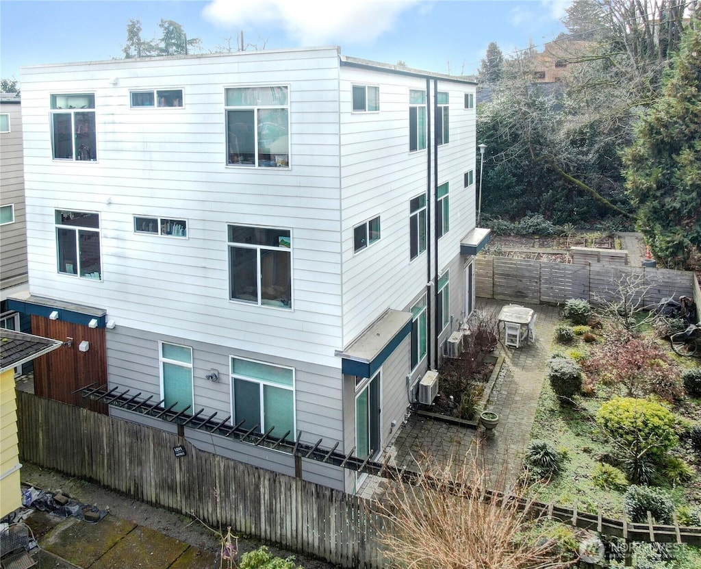 back of house with fence