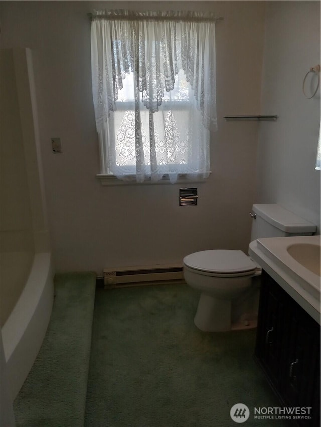 bathroom featuring a baseboard heating unit, toilet, and vanity