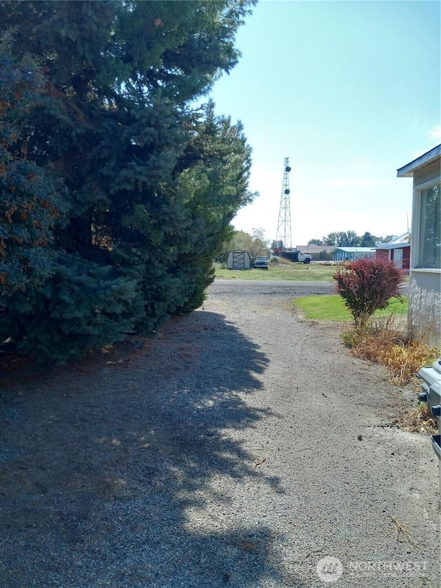 view of street with gravel driveway