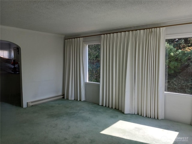 spare room with arched walkways, crown molding, a textured ceiling, carpet floors, and a baseboard heating unit