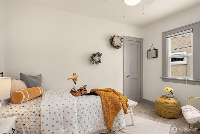 carpeted bedroom featuring a ceiling fan and baseboards