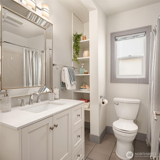 bathroom with visible vents, baseboards, toilet, tile patterned floors, and vanity