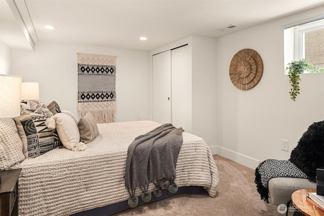 carpeted bedroom featuring recessed lighting, a closet, baseboards, and visible vents