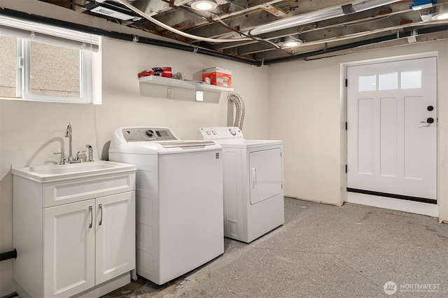 laundry room featuring cabinet space, independent washer and dryer, and a sink