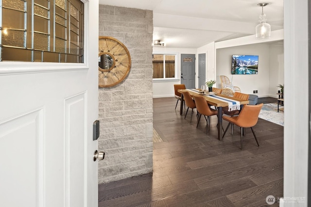 dining room with baseboards and dark wood finished floors