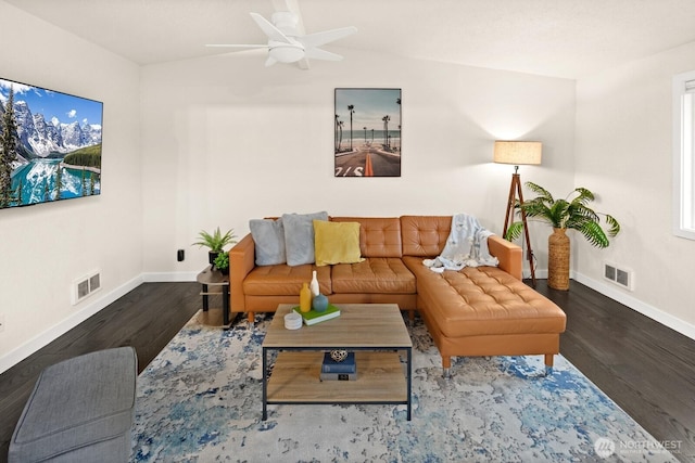 living area featuring wood finished floors, visible vents, and baseboards