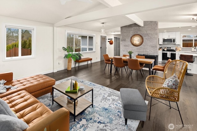 living area featuring vaulted ceiling with beams, baseboards, and dark wood-type flooring