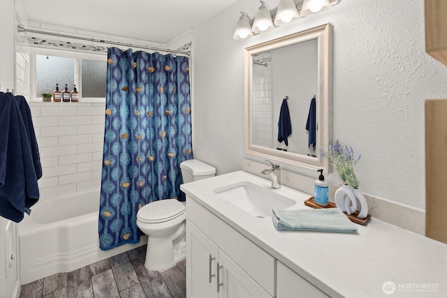 bathroom with shower / bath combination with curtain, a textured wall, toilet, wood tiled floor, and vanity