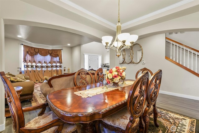 dining room with baseboards, stairway, wood finished floors, a notable chandelier, and recessed lighting