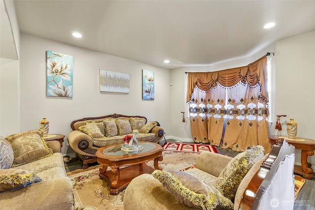 living room featuring baseboards, wood finished floors, and recessed lighting