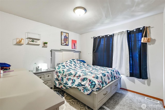 bedroom with visible vents, light carpet, and baseboards