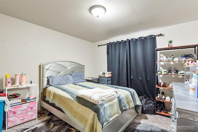 bedroom with dark colored carpet