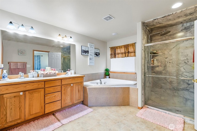 bathroom featuring a garden tub, a sink, visible vents, double vanity, and a stall shower