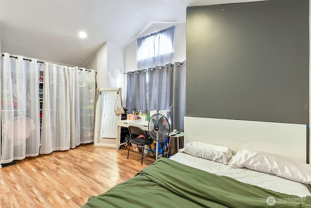 bedroom featuring lofted ceiling and wood finished floors