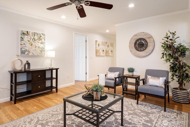 living area featuring crown molding, baseboards, wood finished floors, and recessed lighting