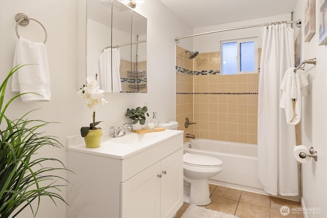 full bath featuring toilet, tile patterned floors, shower / bath combo with shower curtain, and vanity