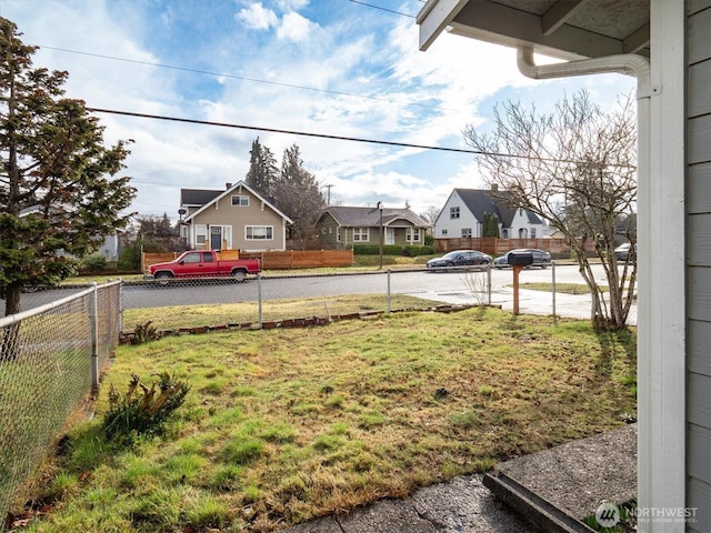 view of yard featuring a residential view and fence