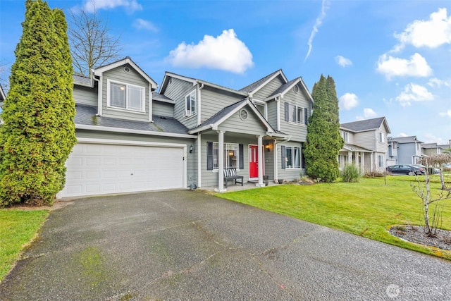 traditional home with driveway, a front lawn, a garage, and a shingled roof