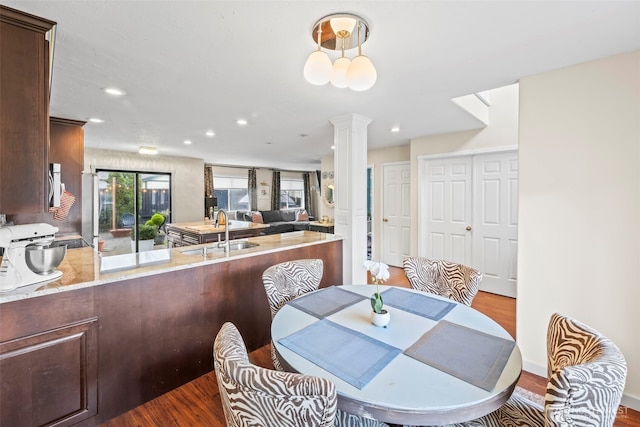 dining room featuring recessed lighting, decorative columns, and dark wood-style floors