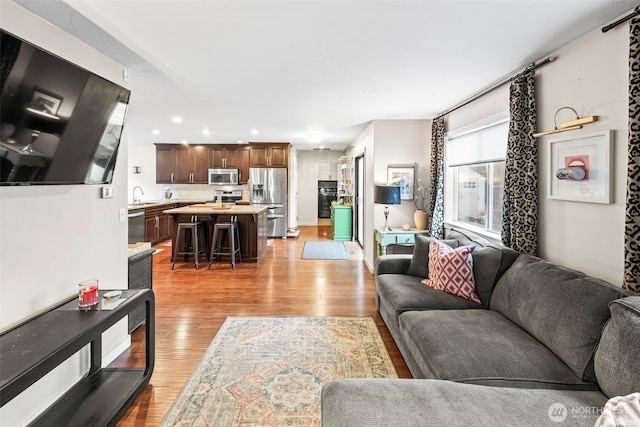 living room with recessed lighting and light wood-style floors