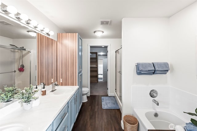 bathroom featuring a sink, visible vents, and a shower stall