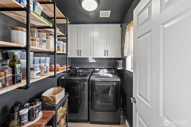 washroom with cabinet space, visible vents, and independent washer and dryer