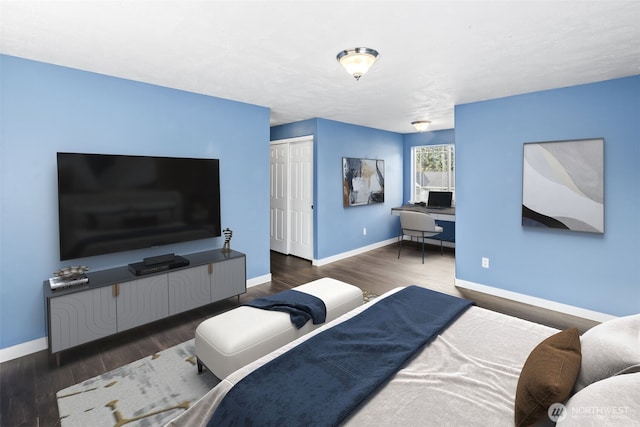 bedroom featuring a closet, baseboards, and wood finished floors