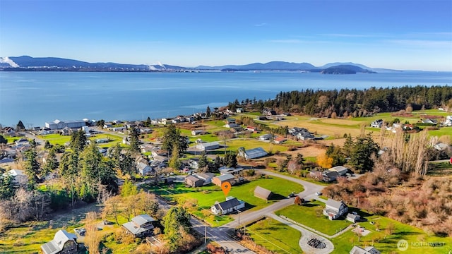 drone / aerial view with a residential view and a water and mountain view