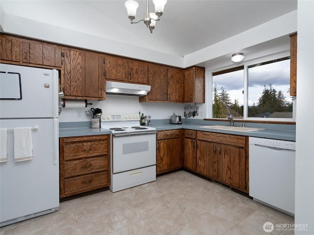 kitchen featuring under cabinet range hood, white appliances, a sink, vaulted ceiling, and light countertops