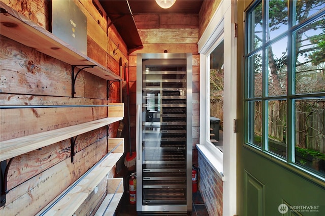 interior space featuring wood walls and beverage cooler