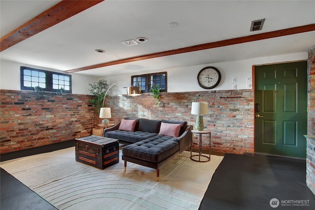 living room with visible vents, brick wall, a wainscoted wall, and beam ceiling