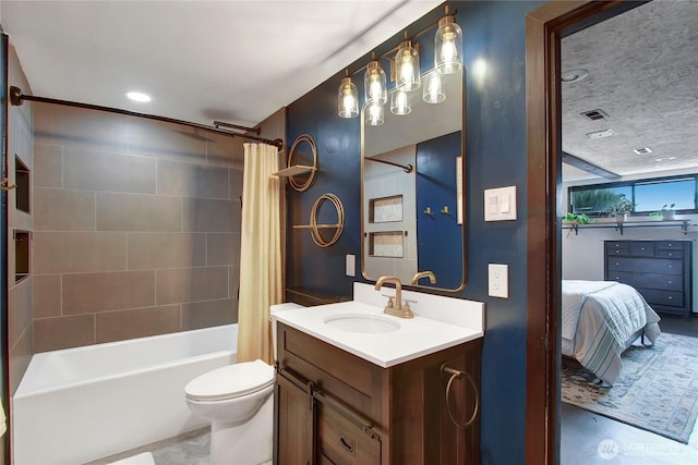 bathroom featuring toilet, shower / tub combo, vanity, visible vents, and ensuite bath