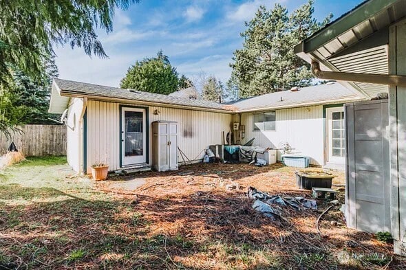 back of house featuring fence