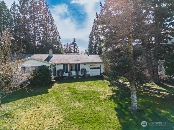 ranch-style home featuring a front yard and an attached garage