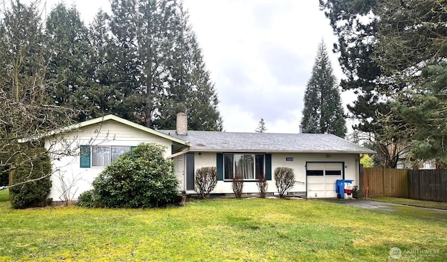 ranch-style home with a chimney, aphalt driveway, an attached garage, fence, and a front yard