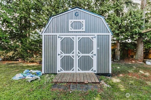 view of shed with fence