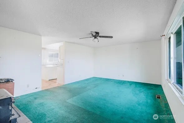 spare room with a textured ceiling and visible vents