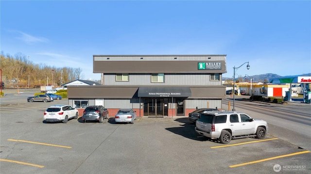 view of building exterior with uncovered parking