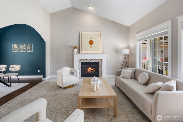 9100 Lewis Dr NE, Lacey, WA 98516 - living area with vaulted ceiling, a tile fireplace, and wood finished floors