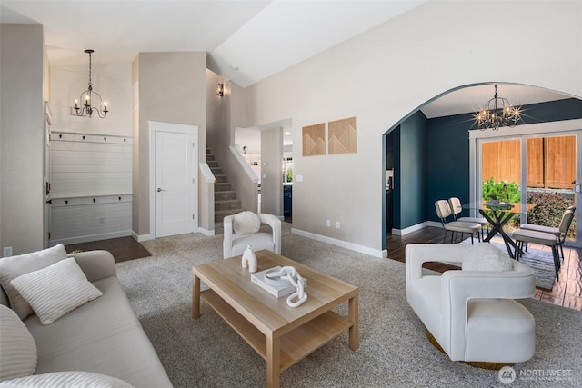 9100 Lewis Dr NE, Lacey, WA 98516 - living room featuring a chandelier, arched walkways, stairs, carpet flooring, and high vaulted ceiling