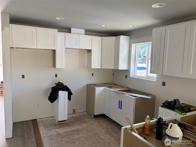 kitchen featuring white cabinetry, wood finished floors, and recessed lighting