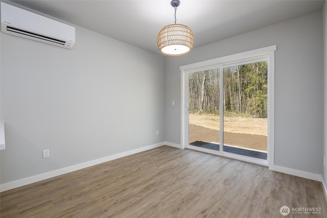6490 Watson Loop, Maple Falls, WA 98266 - spare room with baseboards, wood finished floors, and a wall unit AC