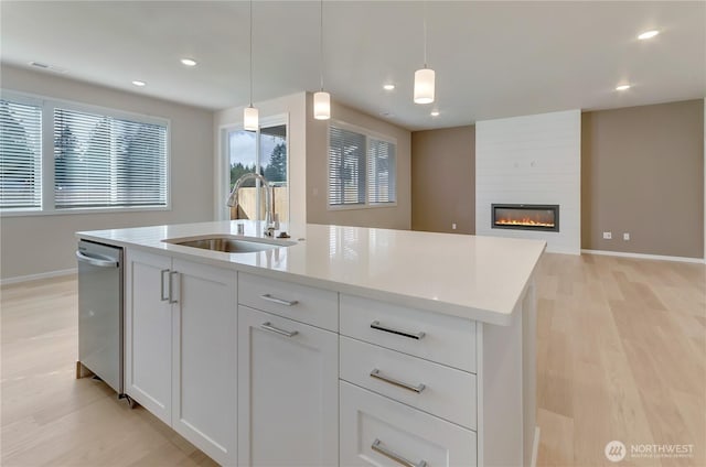 3467 183rd Street Ct E, Tacoma, WA 98446 - kitchen featuring an island with sink, white cabinets, a sink, and decorative light fixtures