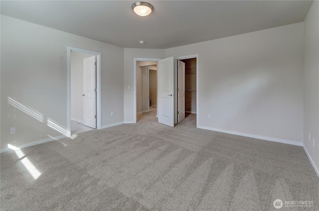 3467 183rd Street Ct E, Tacoma, WA 98446 - unfurnished bedroom with light carpet, a spacious closet, baseboards, and a closet