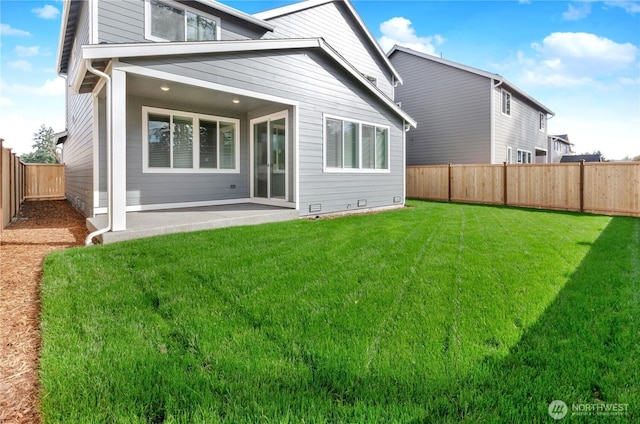 3467 183rd Street Ct E, Tacoma, WA 98446 - rear view of house with a fenced backyard, a lawn, and a patio