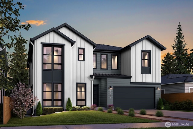 modern inspired farmhouse featuring a garage, fence, driveway, a yard, and board and batten siding